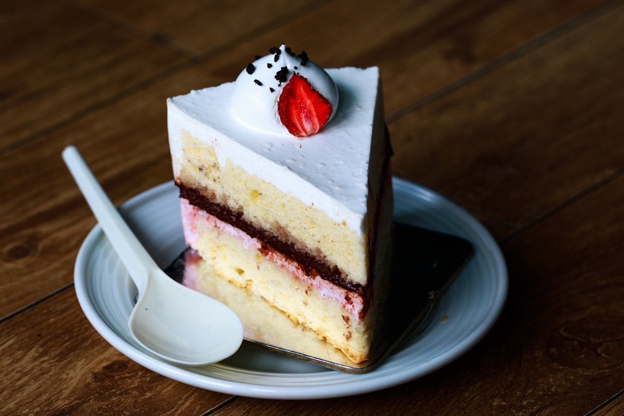 Indulge in this mouthwatering slice of strawberry cream cake, perfect for dessert lovers.