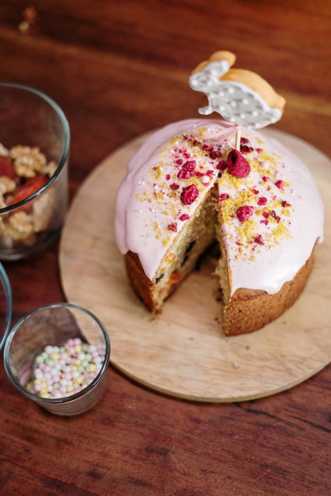 Delicious homemade Easter cake with bunny decor and vibrant topping on a wooden table.